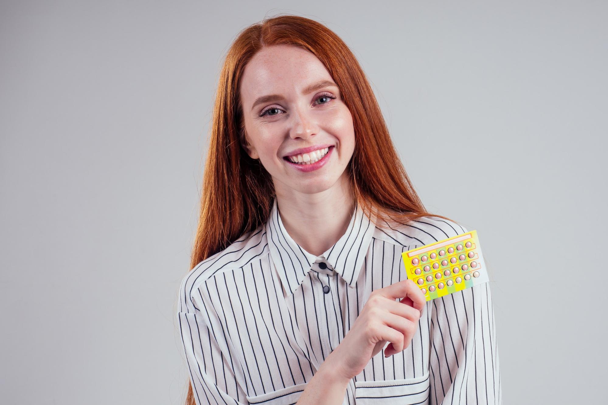 Woman holding birth control