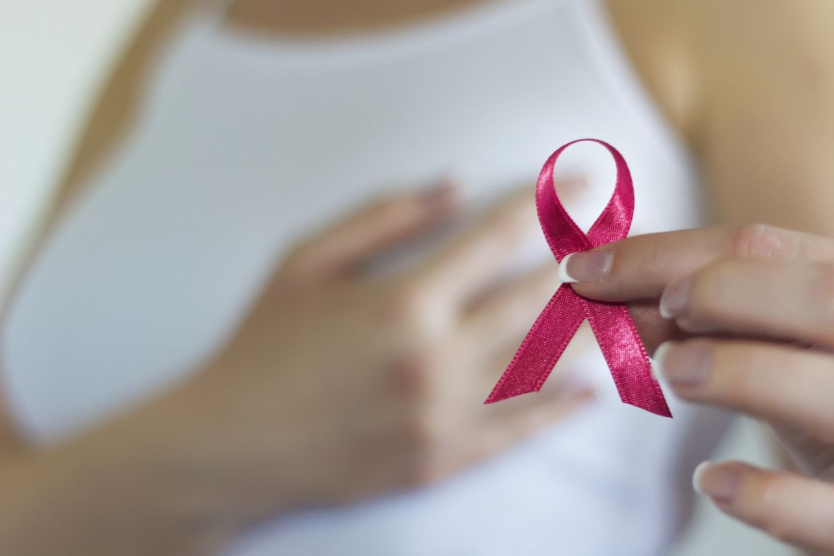 Woman holding a breast cancer ribbon